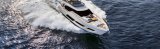Ferretti yacht cruising on water with people sitting on deck