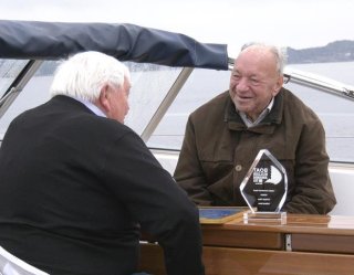 Retired CEO Arne Skauen presents Mr. Rassy with his reward.